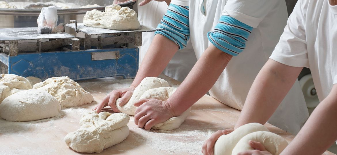 bakery chef's kneading dough