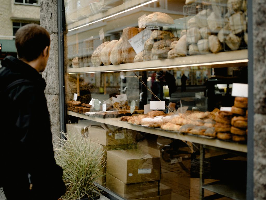 Man looking a bread in a bakery window